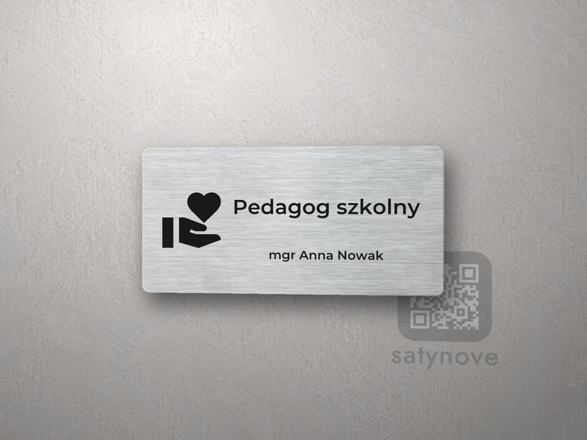 Srebrna tabliczka na drzwi z piktogramem i napisem Pedagog szkolny