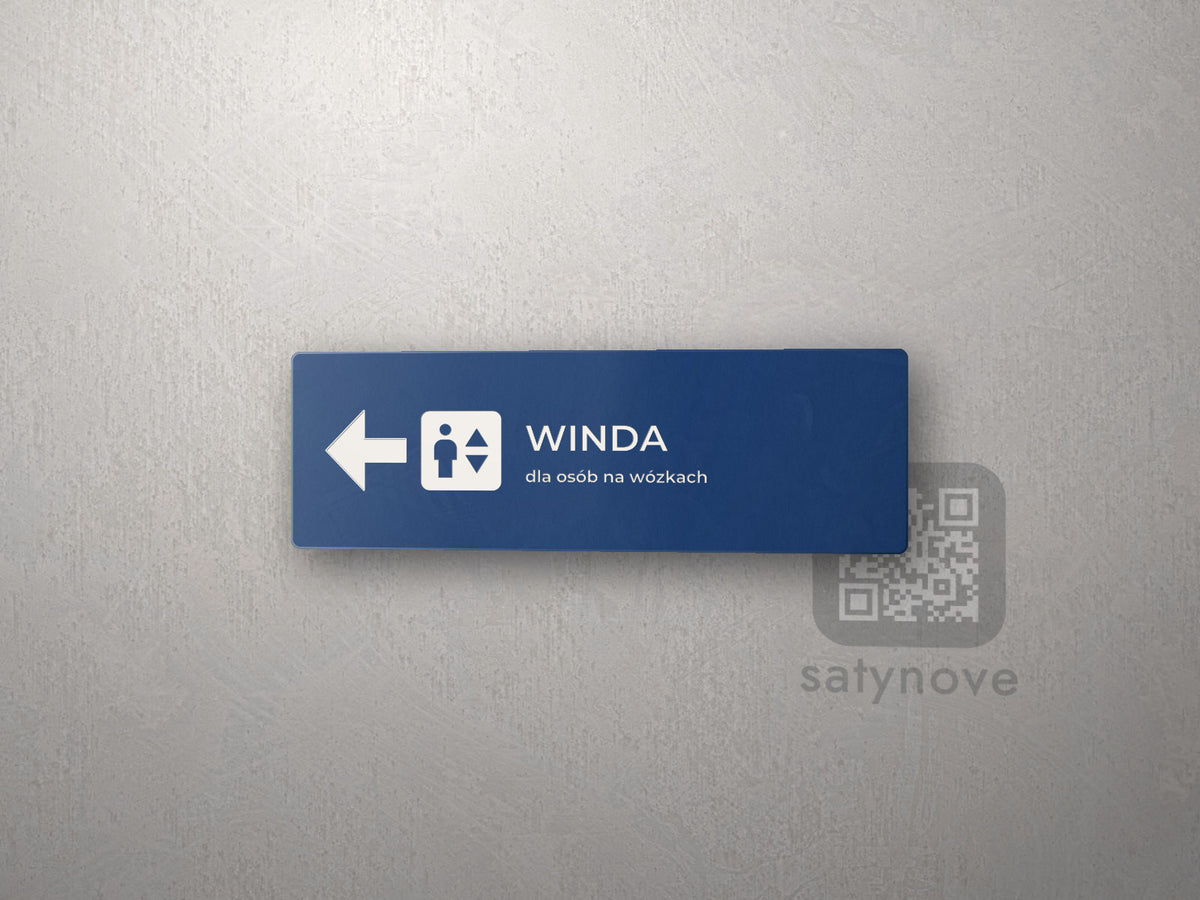 Granatowa tabliczka kierunkowa Winda ze strzałką w lewo i symbolem windy