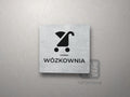 Kwadratowa tabliczka z piktogramem i podpisem WÓZKOWNIA