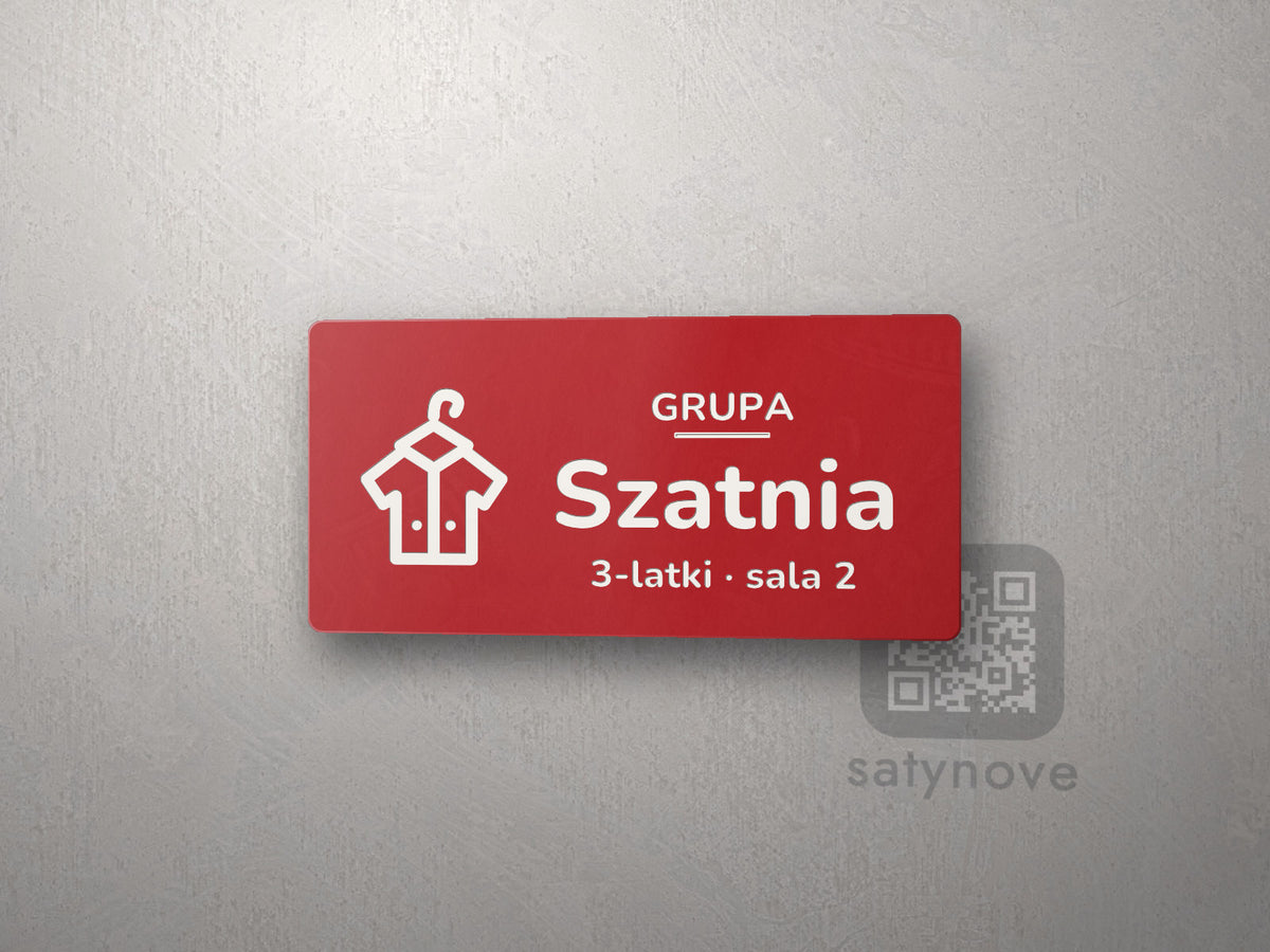 Czerwona tabliczka z obrazkiem i napisem Szatnia