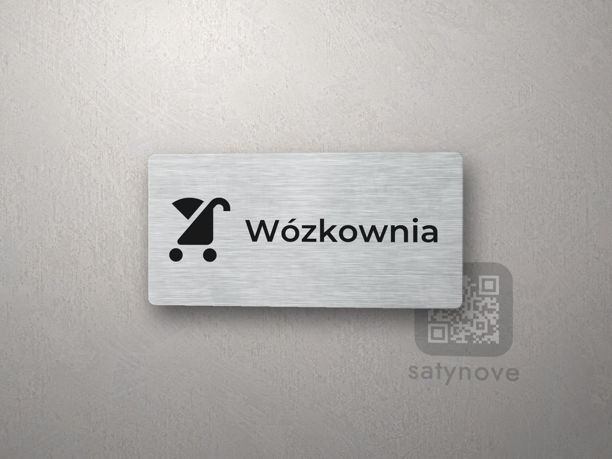 Srebrna tabliczka z piktogramem i napisem Wózkownia
