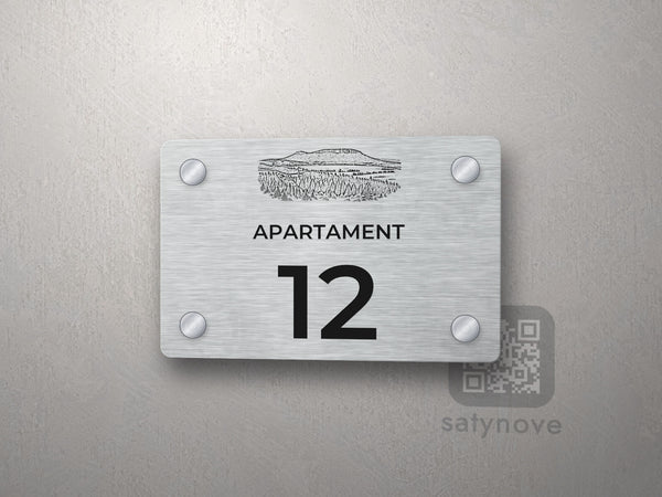 Srebrna tabliczka z numerem apartamentu 12 i grafiką Gór Stołowych