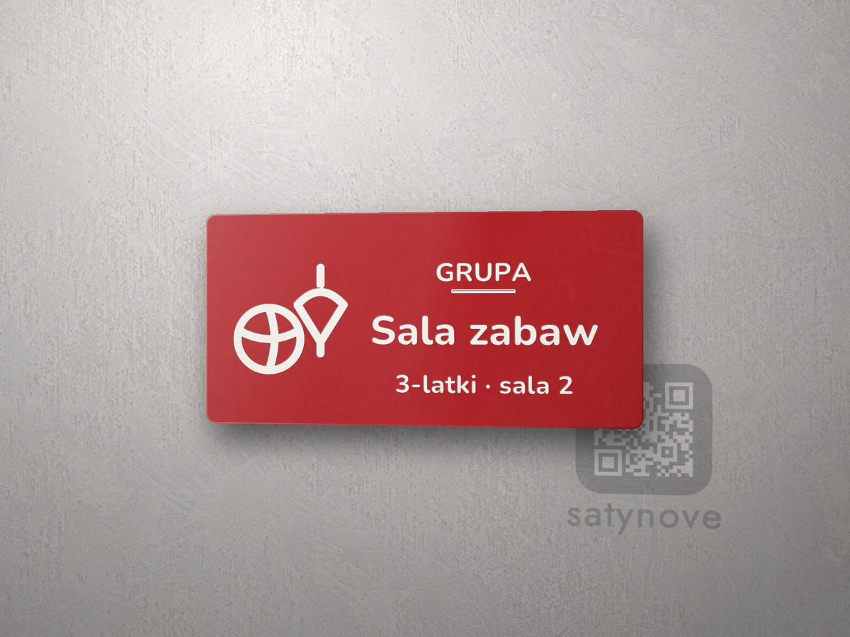 Czerwona tabliczka z obrazkiem i napisem Sala zabaw