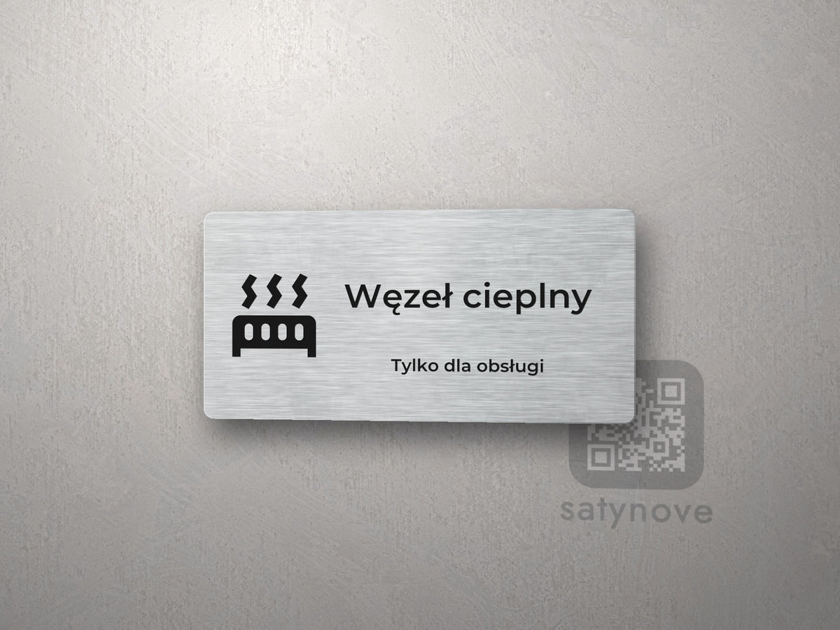 Srebrna tabliczka z piktogramem i napisem Węzeł cieplny