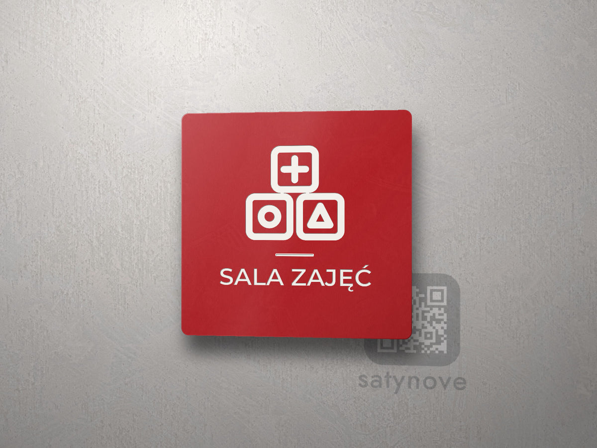 Czerwona kwadratowa tabliczka z obrazkiem i napisem SALA ZAJĘĆ
