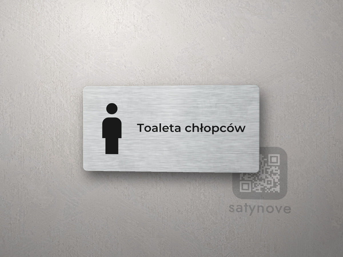Srebrna tabliczka na drzwi z piktogramem i napisem Toaleta chłopców