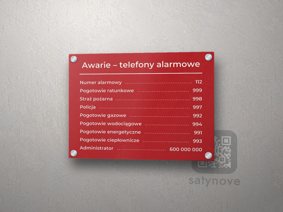 Czerwona tablica „Awarie – telefony alarmowe” z numerami po kropkach