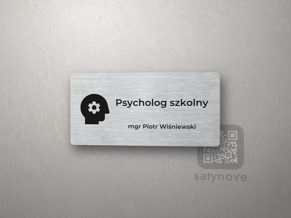 Srebrna tabliczka na drzwi z piktogramem i napisem Psycholog szkolny