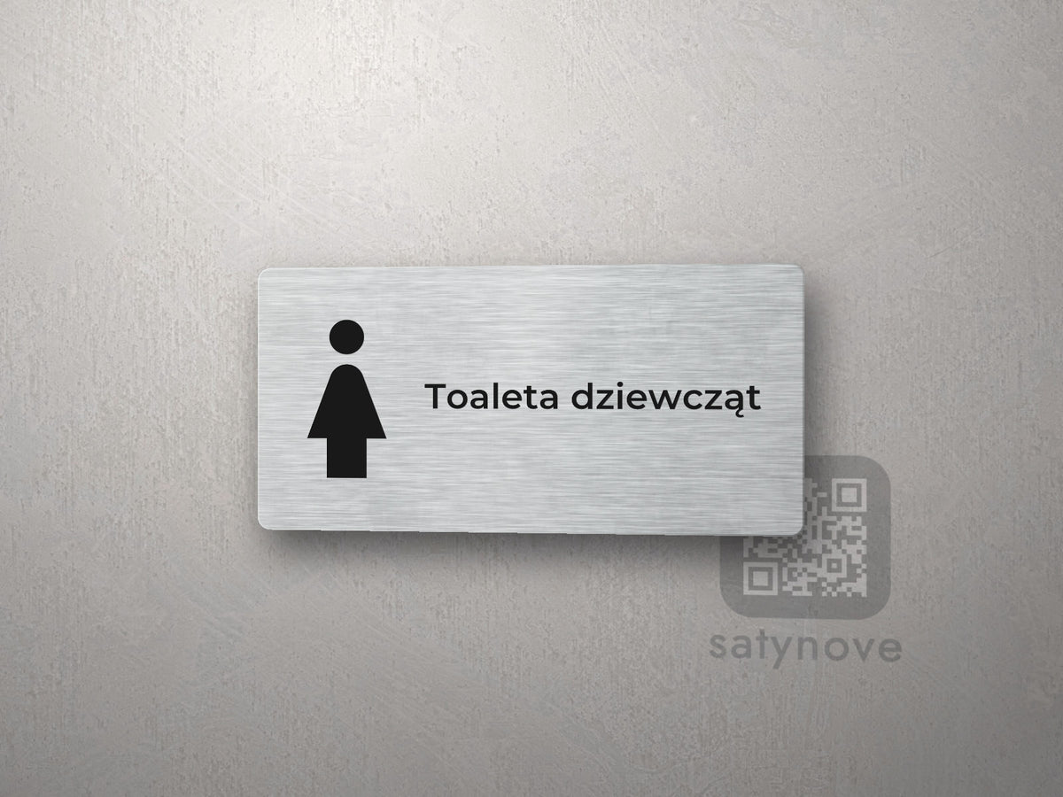 Srebrna tabliczka na drzwi z piktogramem i napisem Toaleta dziewcząt