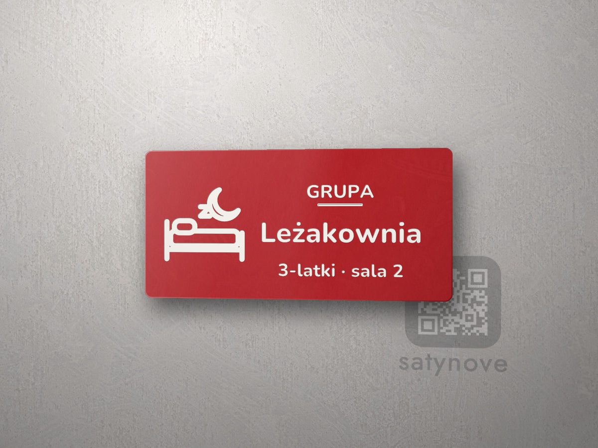 Czerwona tabliczka z obrazkiem i napisem Leżakownia