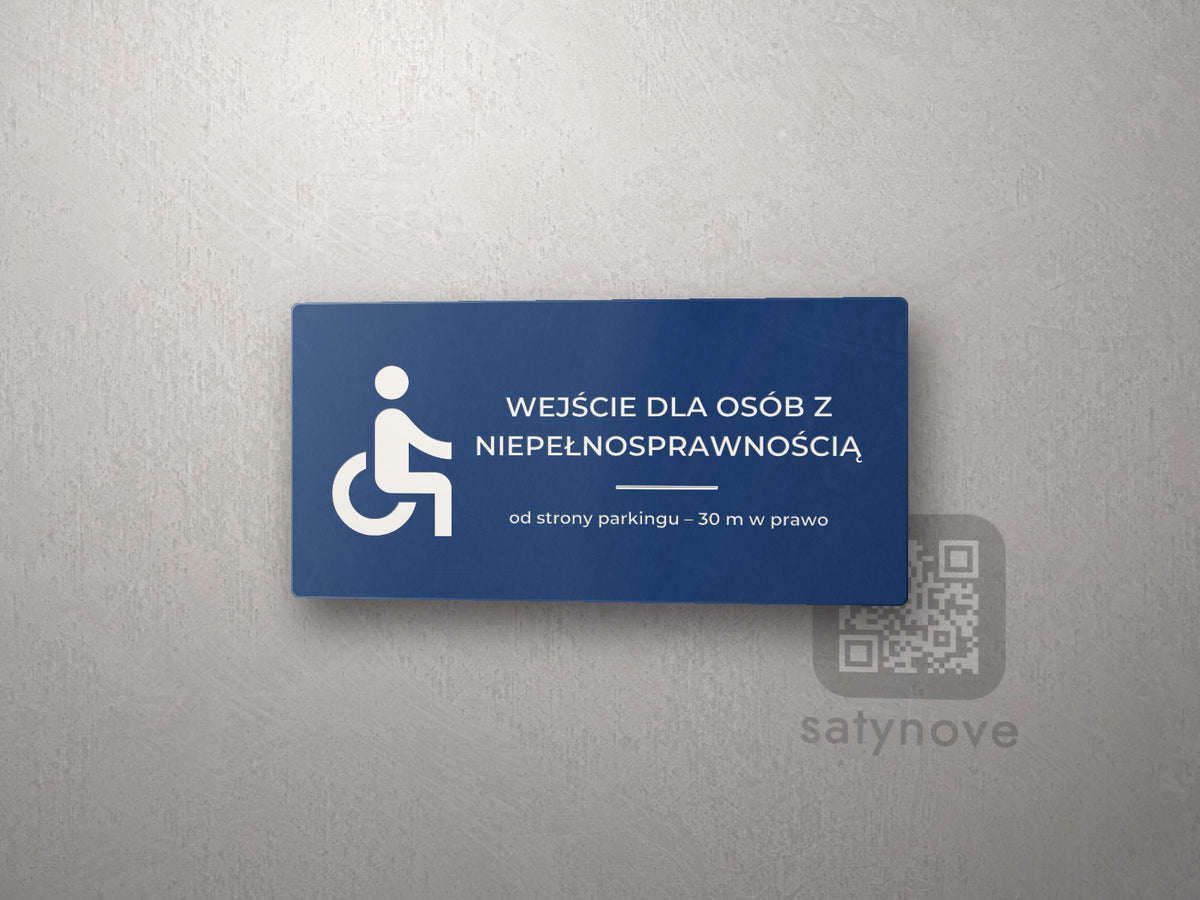 Tabliczka Wejście dla osób z niepełnosprawnością z symbolem wózka i dopiskiem o drodze