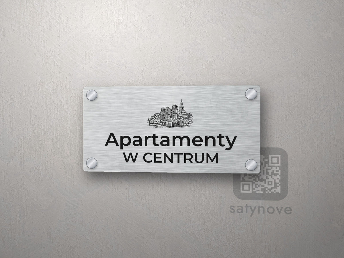 Srebrny szyld z grafiką Katowic i napisem Apartamenty w centrum
